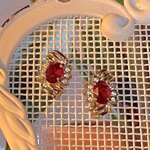 Vintage gold tone earrings with a faux ruby stone